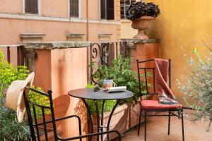 a small table and chairs sitting on a patio at Hotel Fori Imperiali in Rome