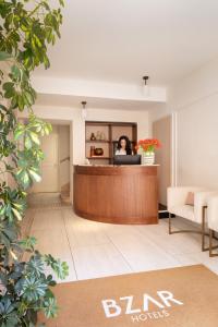 a woman sitting at the reception desk in a hotel lobby at Hotel Fori Imperiali in Rome +56 photos