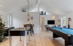 a room with a pool table and a living room at Beautiful Home In Ringkøbing With Sauna in Ringkøbing