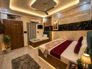 a bedroom with a large bed and a couch at Hotel Jyoti Stay Inn 2 Min to Ram Tample in Ayodhya +9 photos