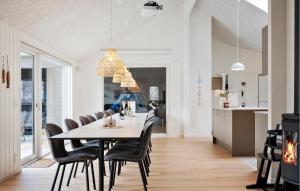 a dining room with a table and chairs at Beautiful Home In Ringkøbing With Sauna in Ringkøbing