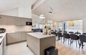 a kitchen and dining room with a table and chairs at Beautiful Home In Ringkøbing With Sauna in Ringkøbing