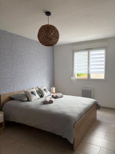a bedroom with a large bed and a window at L'essentiel in Hambach