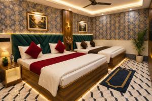 a hotel room with two beds in a room at Hotel Jyoti Stay Inn 2 Min to Ram Tample in Ayodhya