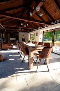 a large wooden table and chairs on a patio at Casa Mila in Belish