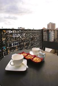 a table with two cups and a bowl of food at Perada Suite & Room in Istanbul
