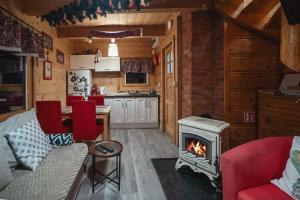 a kitchen and living room with a stove at Góralski Dom - Osada Gawlaki in Zakopane