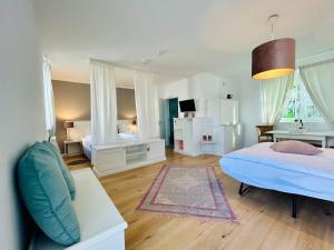 a bedroom with a bed and a couch in it at Domizil Gols, Studios Am Anger in Gols