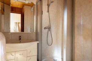 a bathroom with a shower and a sink at L'Arveyron Open House in Chamonix +62 photos