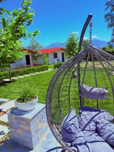 a bird cage with pillows in a yard at Sandri Nature Lodge in Karahaxh