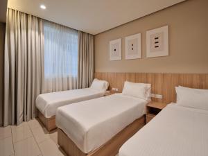 a hotel room with two beds and a window at Hamad - Salmiya -Family only in Kuwait