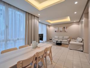 a room with a table and chairs and a living room at Hamad - Salmiya -Family only in Kuwait