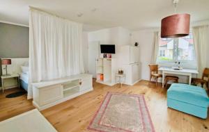 a living room with a bed and a dining room at Domizil Gols, Studios Am Anger in Gols