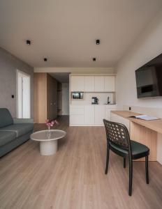 a living room with a couch and a table at MARSHALL Golf & Wellness Hotel in Sokolov +54 photos