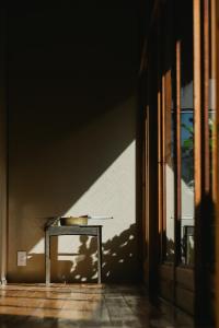 a table in a room with a shadow on a wall at 宿屋 余白丨yadoya yohaku in Wakayama +34 photos