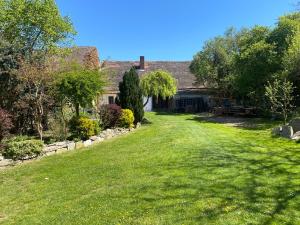 a yard of a house with a grass yard at Stodola v zahradě in Vodňany