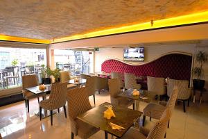 a restaurant with tables and chairs in a room at Perada Suite & Room in Istanbul