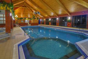 a large swimming pool in a building at Forest Hills Hotel & Country Club in Frodsham