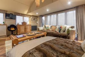 a living room with a couch and a table at The Bothy in Ringstead
