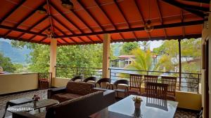 a patio with a table and chairs on a balcony at Nature View Villa in Badulla