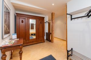 a room with a wooden cabinet and a table at Apartment AM MARKT Eisenach in Eisenach