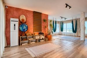 a large living room with wooden floors and red walls at Caesar Blue Collection Nothern Cyprus whith Bedroom Residences in Ayios Dhometios