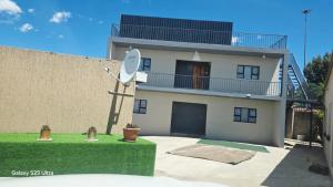 a house with a satellite on the side of it at MOHALALITOE B and B in Maseru