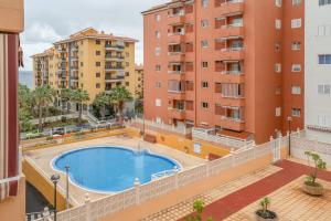 an apartment with a swimming pool and buildings at Brisa Caletillas in Punta Larga