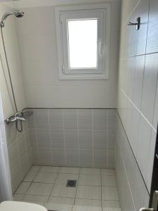 a bathroom with a shower and a window at Captains View in Kefallonia +21 photos