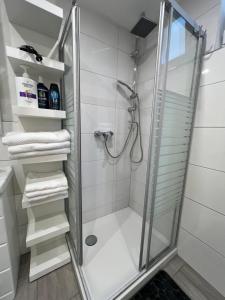 a bathroom with a shower with a glass door at Apartment Marin in Bad Wildbad +22 photos