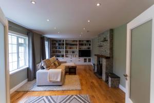a living room with a couch and a fireplace at Kerry Hideaway - Killorglin in Killorglin