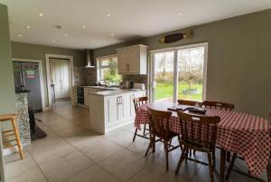a kitchen and dining room with a table and chairs at Kerry Hideaway - Killorglin in Killorglin +10 photos