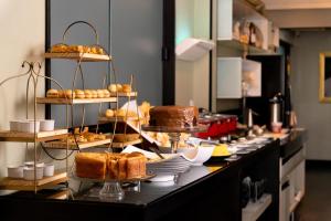 a buffet line with different types of bread and pastries at Picos Hotel in Picos