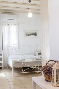a bedroom with a white bed and a table at GLAFKY Retreat in Panormos