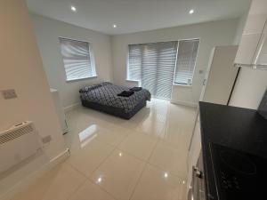 a living room with a couch in the middle of a kitchen at Radstock Road - Room 2 in Southampton