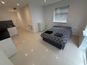 a bedroom with a bed in a white room at Radstock Road - Room 2 in Southampton