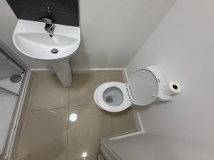 a bathroom with a white toilet and a sink at Radstock Road - Room 2 in Southampton