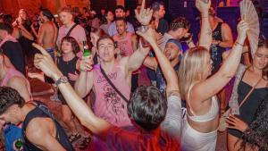 a group of people dancing at a party at Lushy Hostel Kuta Legian in Legian