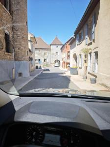 a view of a street from the dashboard of a car at L'Ecrin de l'Abreuvoir in Marnay +9 photos