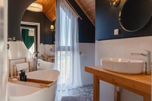 a bathroom with two sinks and a large mirror at Góralski Dom - Osada Gawlaki in Zakopane +43 photos