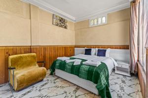a bedroom with a bed and a chair at Riad Rêve D'Ourika in Ourika