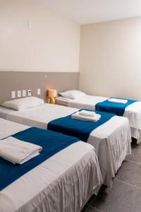a group of three beds in a room at Picos Hotel in Picos +78 photos