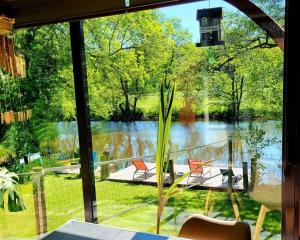 a view of a lake from a window at Chez Nirina proche Puys DuFou in Mortagne-sur-Sèvre