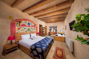 a bedroom with a bed in a room at Cappadocia Tughan Stone House in Uçhisar +86 photos