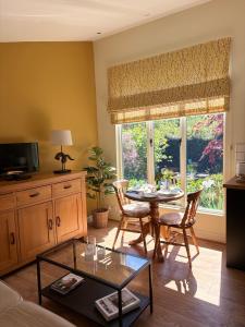 a living room with a table and a window at The Steppes Holiday Cottages in Hereford