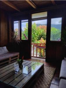 a living room with a couch and a glass table at The Temple III, Mindo in Mindo