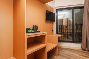 a room with a coffee maker on a counter and a window at RaRa Residence in Mumbai