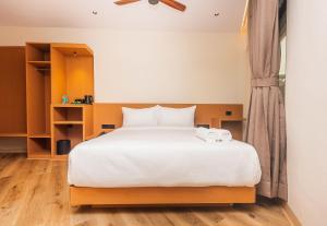 a bedroom with a bed with two towels on it at RaRa Residence in Mumbai