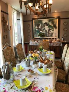 a table with a table cloth with food on it at Moulin de Bapaumes in Nérac