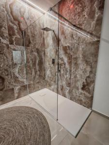 a bathroom with a shower with a glass door at Suite Crystal Home with Jacuzzi in Trapani